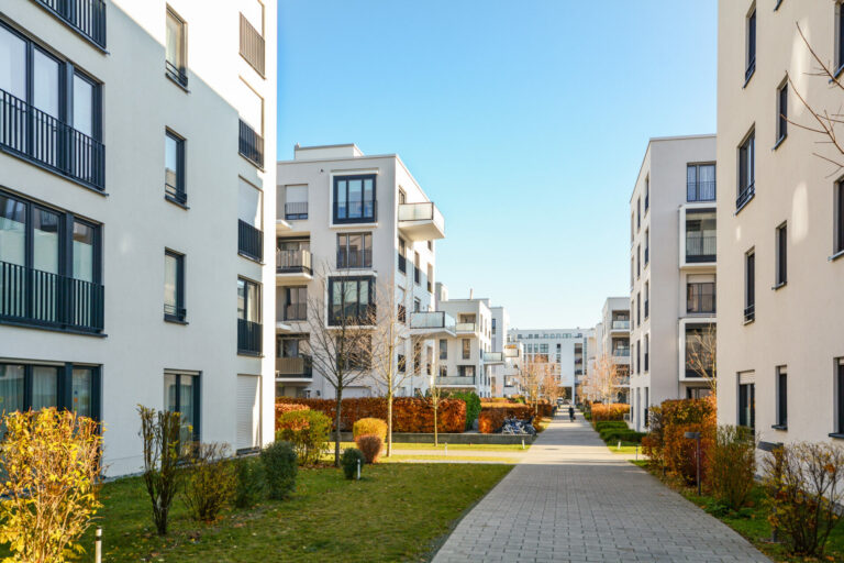 Modern apartment buildings in a green residential area in the city, representing public sector