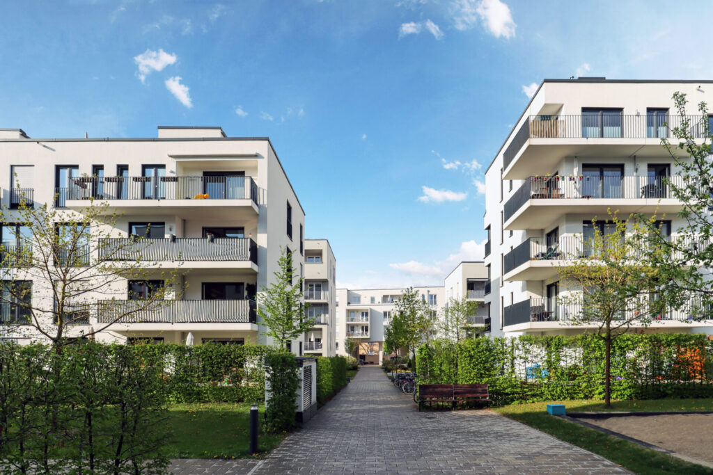 Cityscape of a residential area with modern apartment buildings, representing property management
