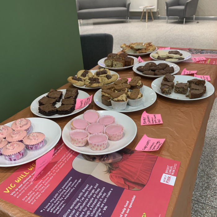 Table full of homemade cakes for breast cancer awareness