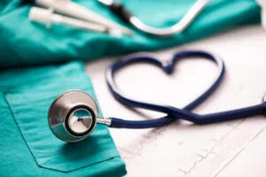 Medical stethoscope twisted in heart shape representing customer care for care home