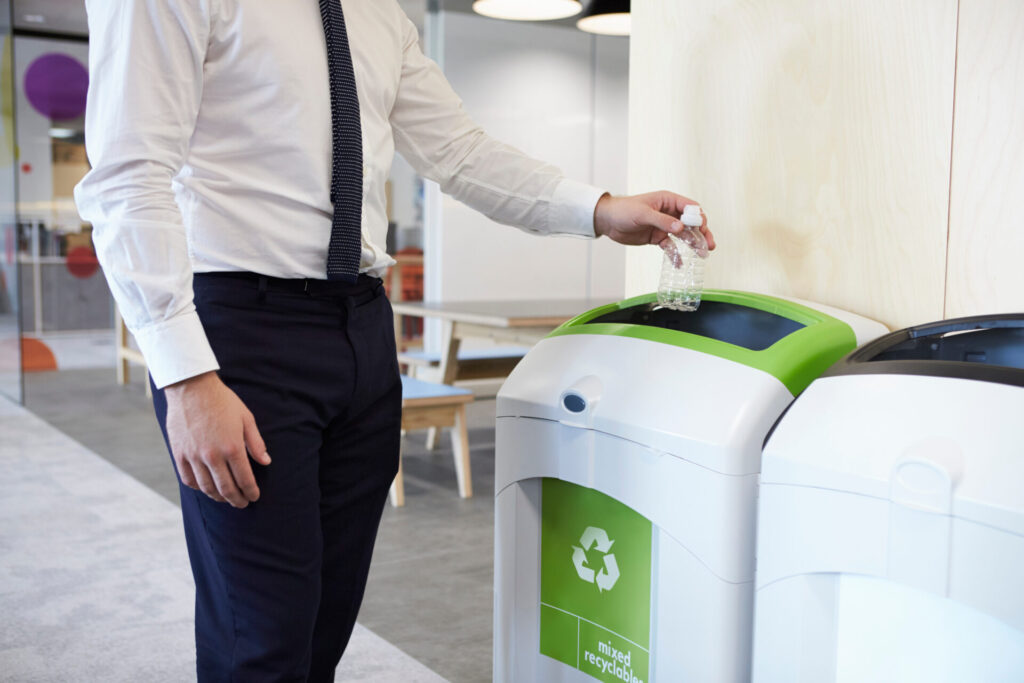 man in businesswear recycling in the workplace