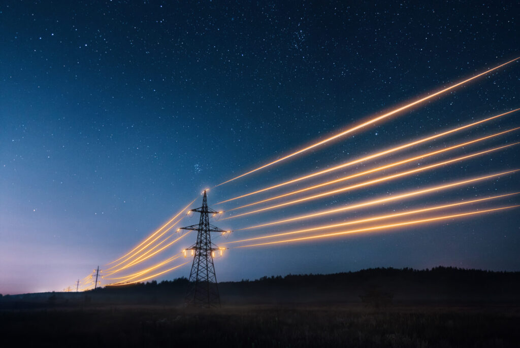 Electricity transmission towers with orange glowing wires representing energy prices