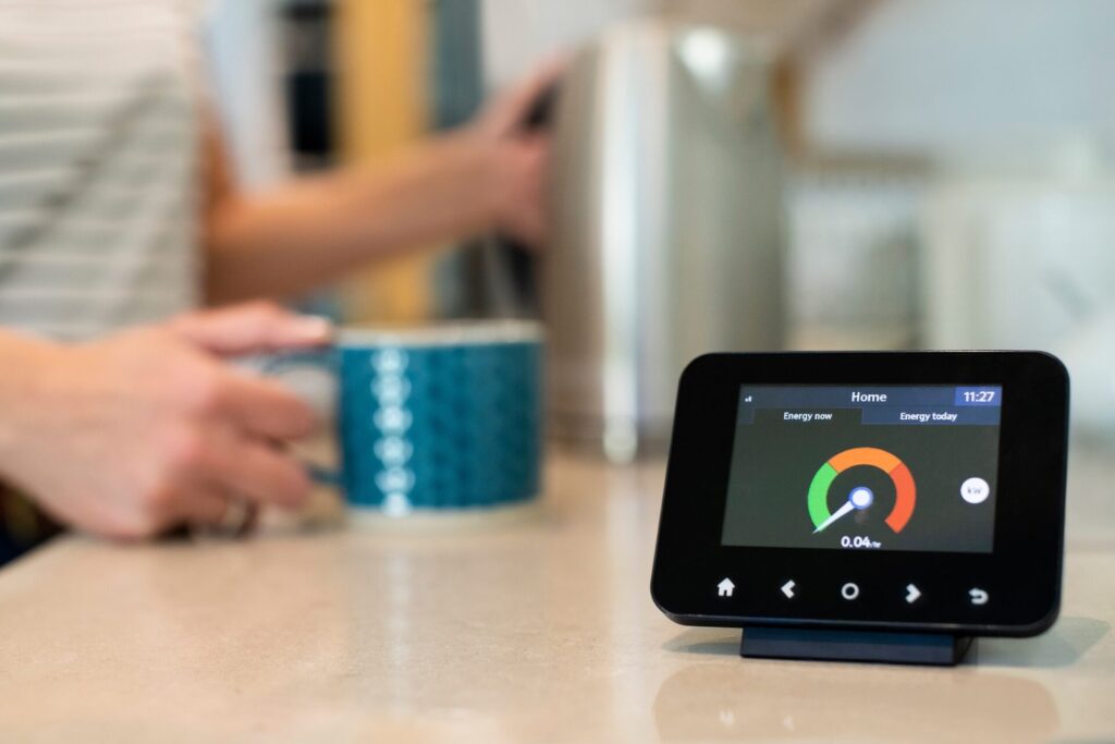 woman holding mug on bench with smart meter in foreground