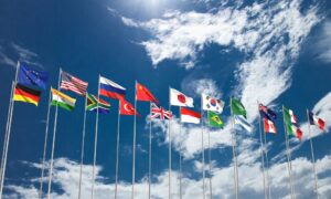 world flags against blue sky representing g20 summit