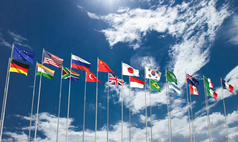 world flags against blue sky representing g20 summit