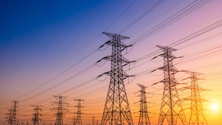 High voltage electricity towers at sunset