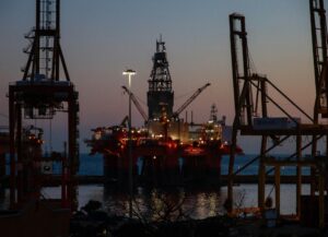 oil drilling at dusk representing oil demand