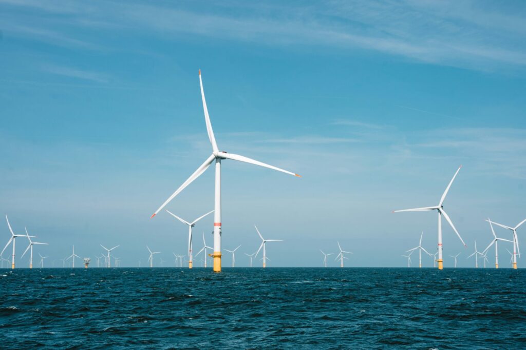 group of offshore wind turbines with blue sky