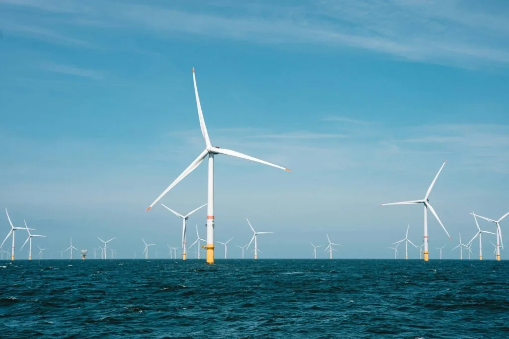 group of offshore wind turbines with blue sky