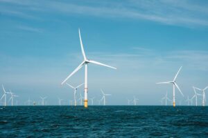 group of offshore wind turbines with blue sky