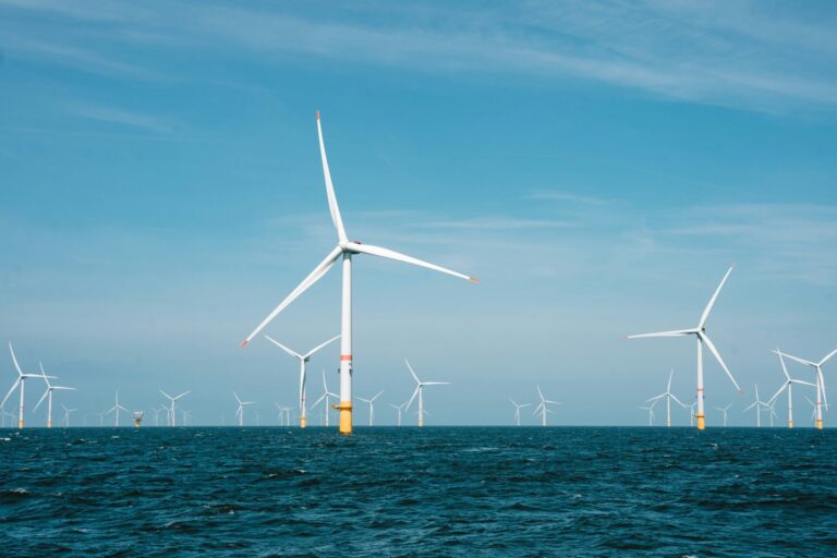 group of offshore wind turbines with blue sky