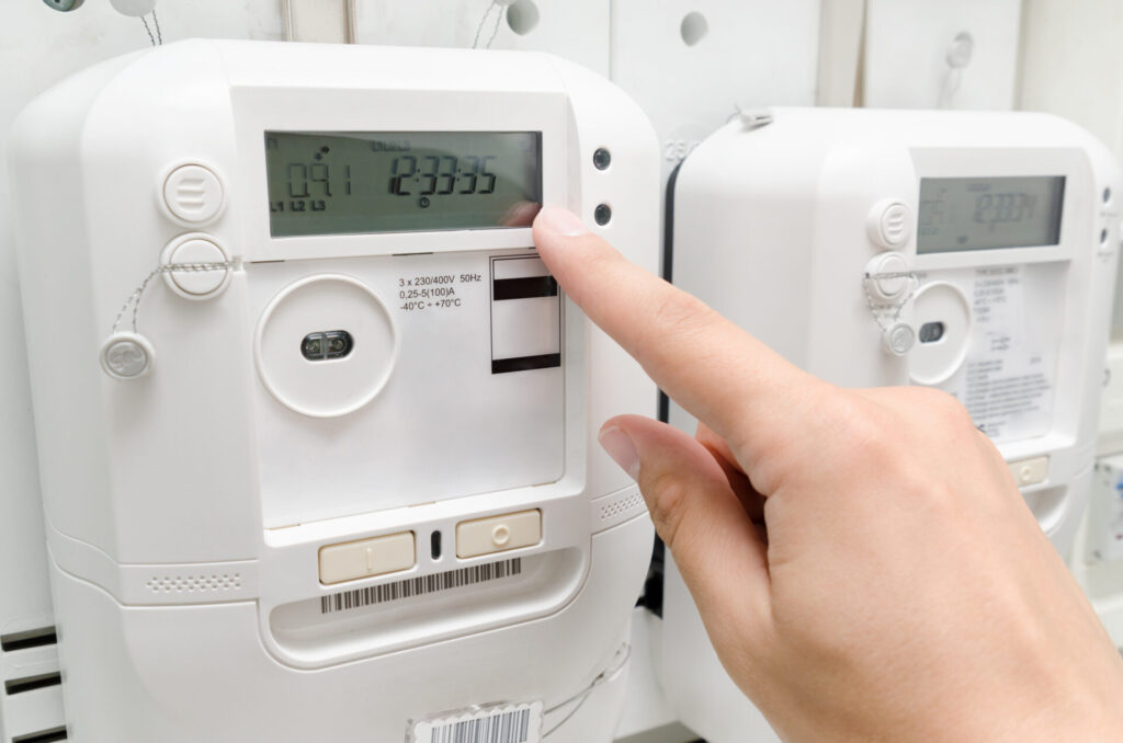 Electric energy meter. Electrical technician servicing metering unit