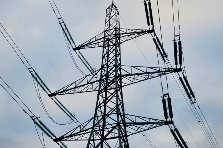pylons against blue sky representing national grid green energy surge