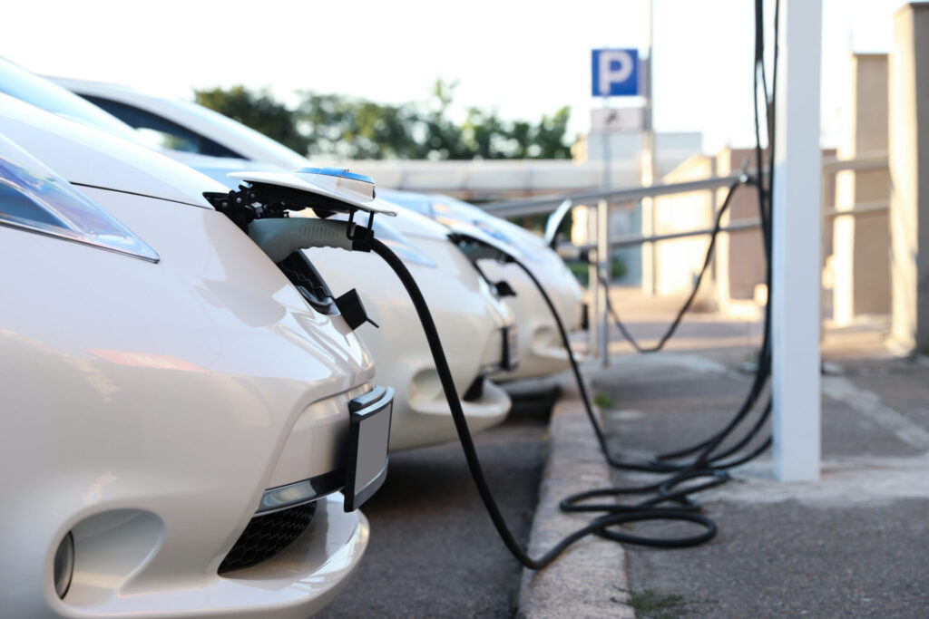 line of electric vehicles on charge in a car park representing the depot charging scheme