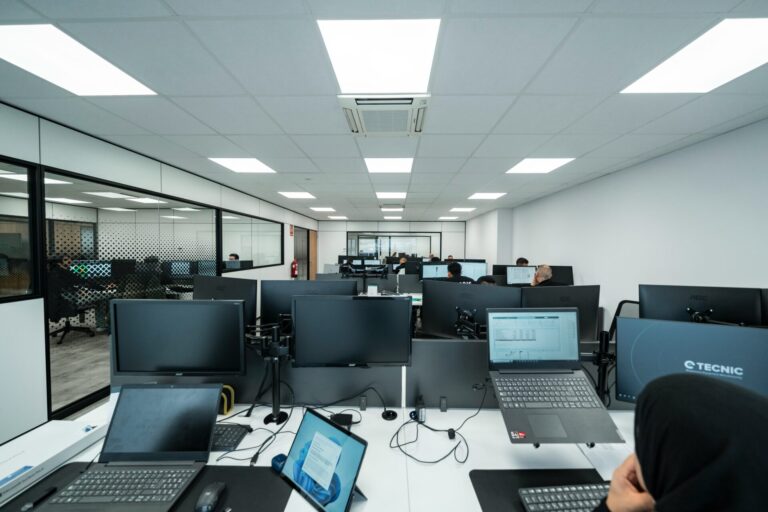 led lighting in office with laptops and monitors representing energy efficiency