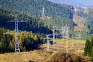 energy pylons on green landscape representing NESO and grid challenges