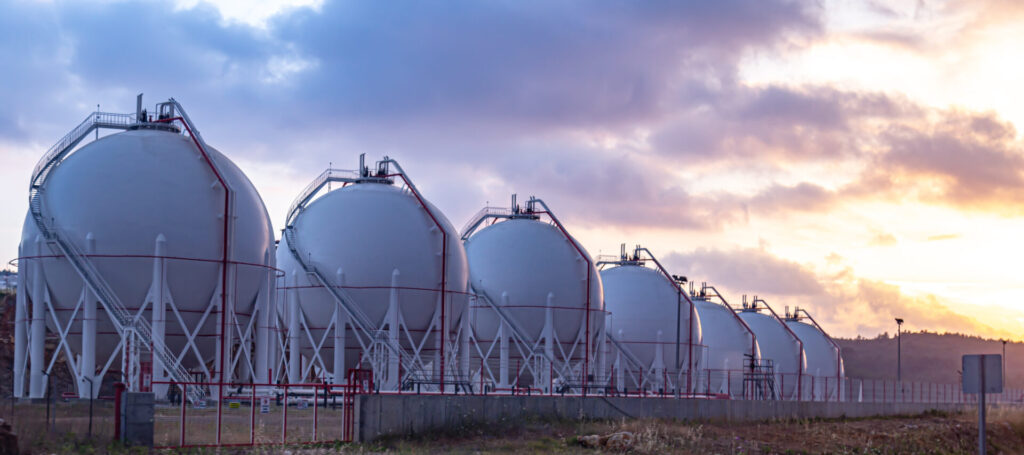 Gas storage tanks at sunset