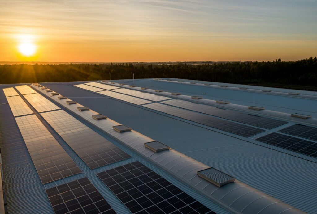solar panels on building roof at sunset