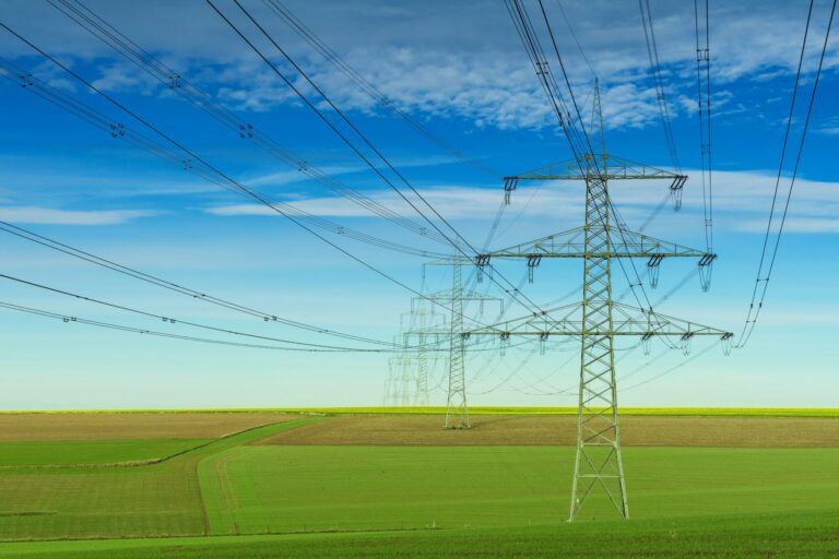 pylons against green grass and blue sky representing rise in business energy costs