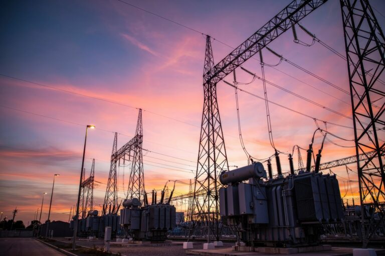 substation with transmission towers against sunset sky representing ofgem investment