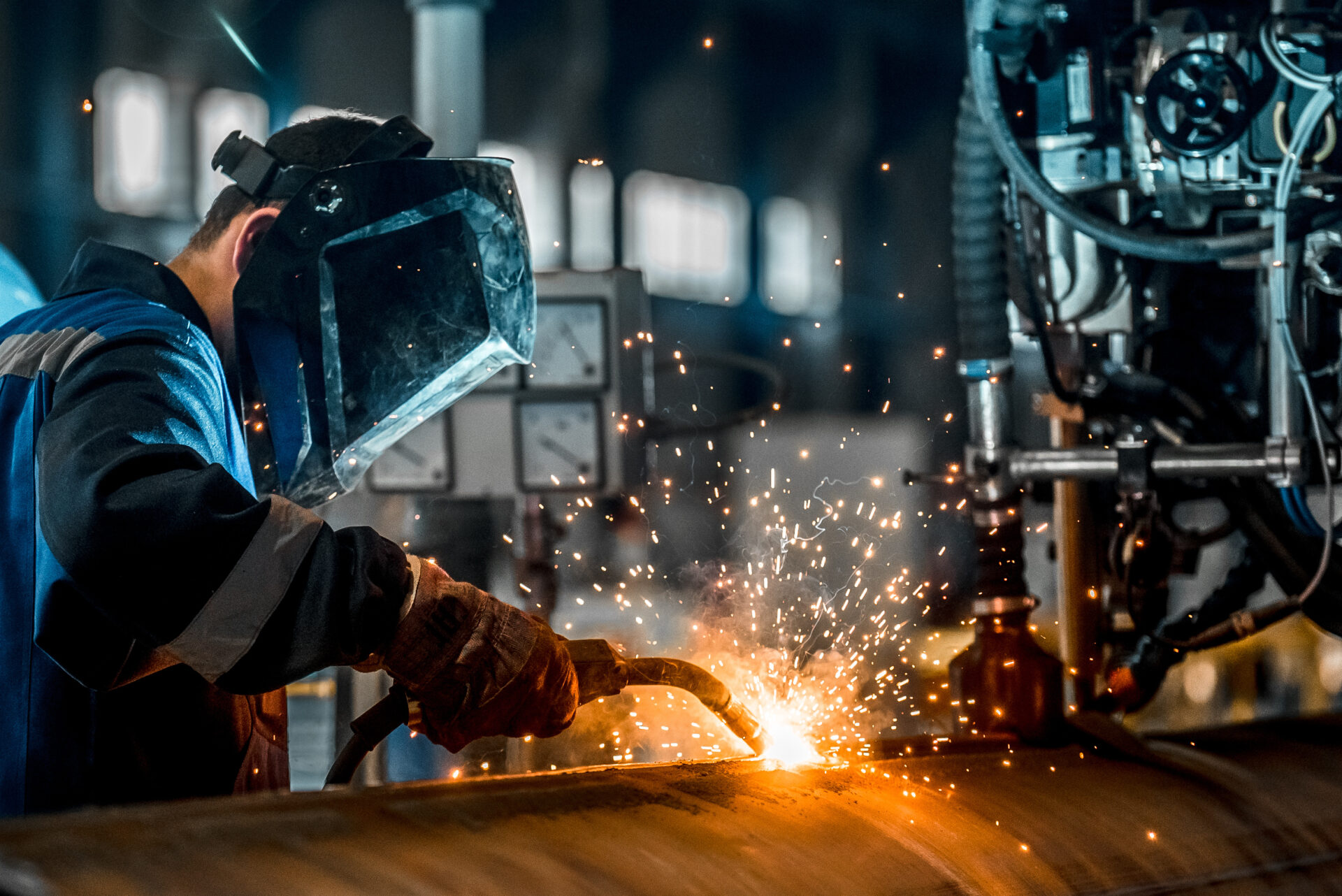 man welding at manufacturing plant representing BICS